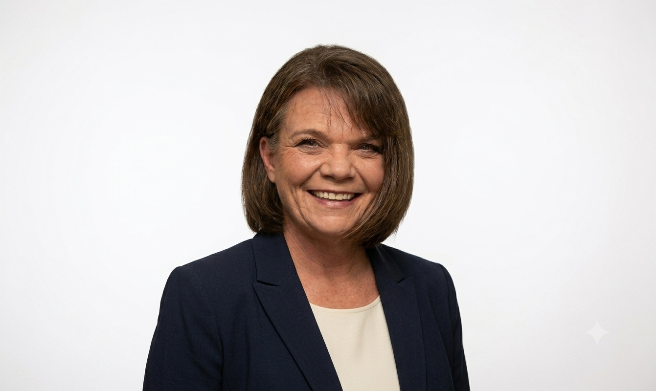 Close-up portrait of a middle-aged woman with short brown hair and a subtle smile.